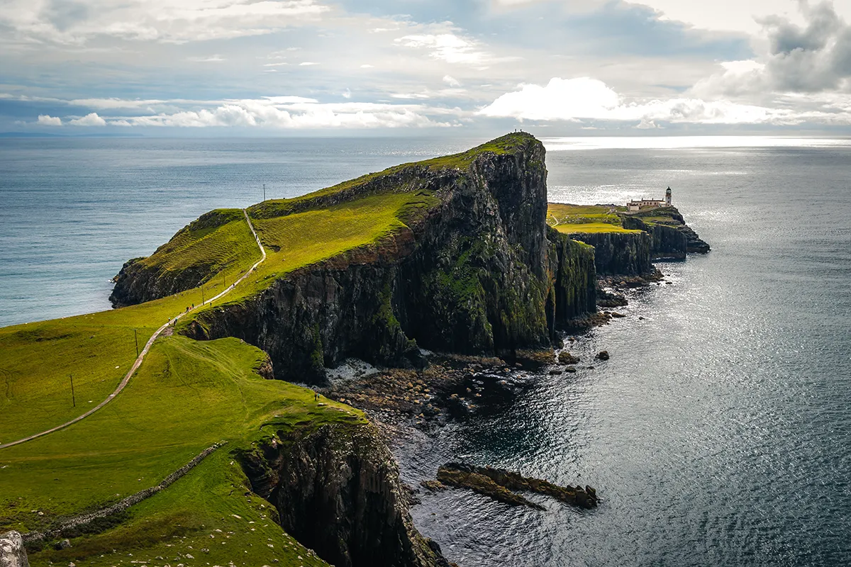 Rugged cliff headland and grassy landscape overlooking the sea near the Hebrides islands