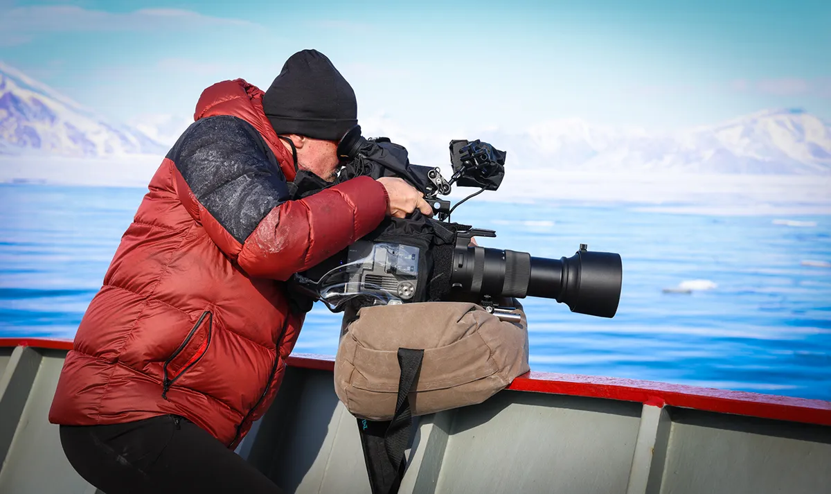 Man filming with video camera.