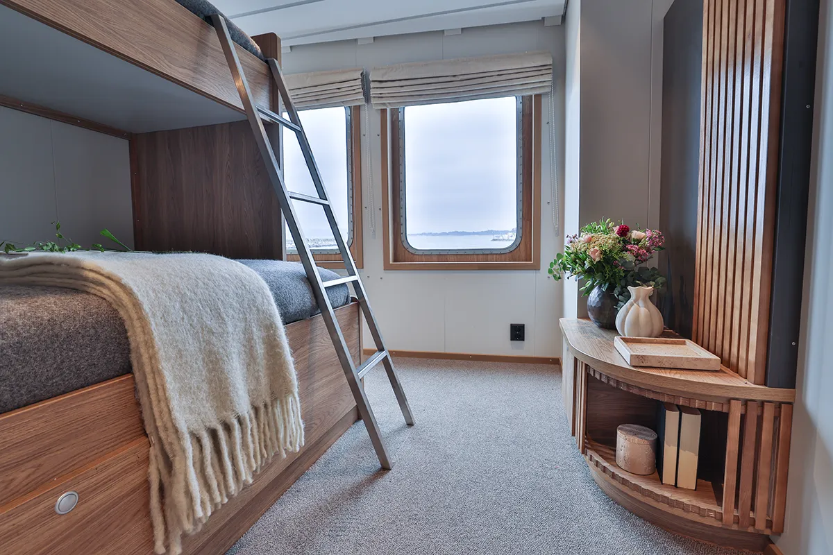 Interior of a single cabin aboard Vikingfjord expedition vessel with bunk bed and sea view window